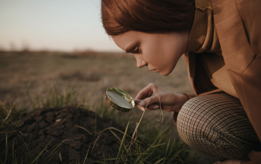 homeschool student looking at her transcript with magnifying glass